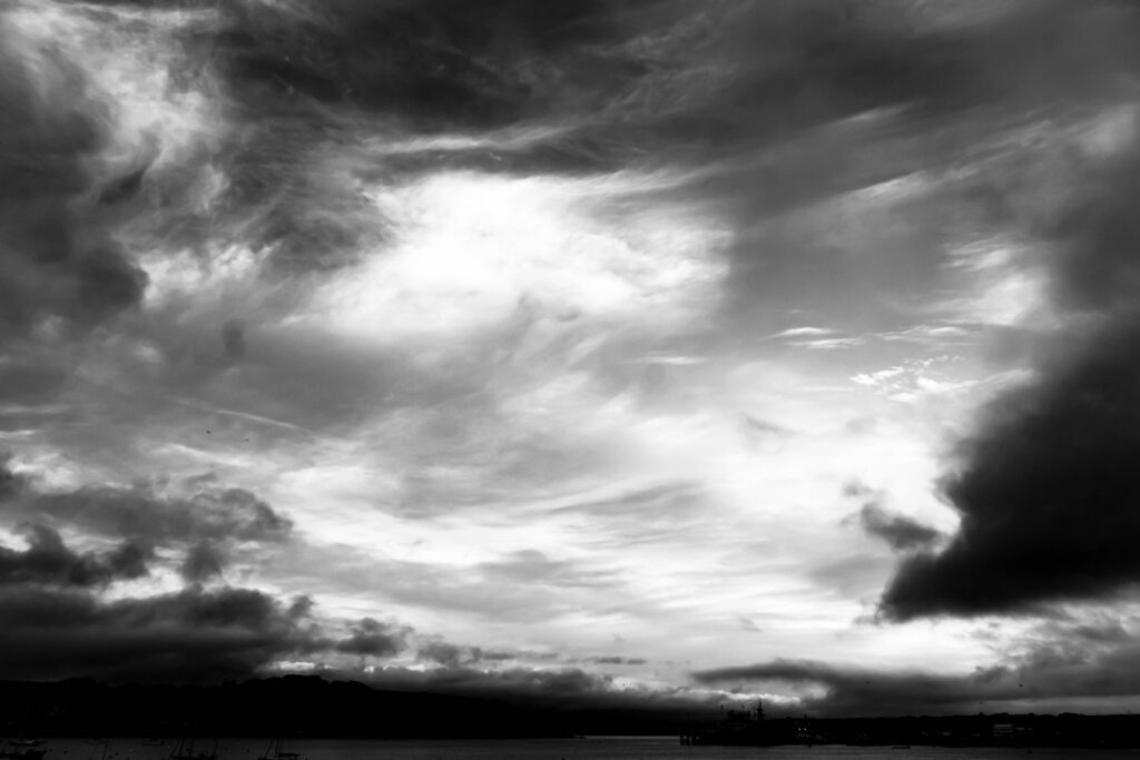 Black and white, wide shot of Falmouth Harbour and clouds